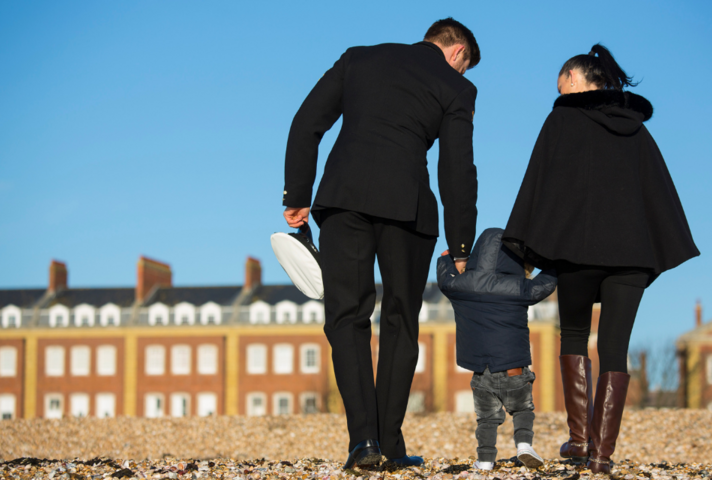 Royal Naval Physical Training instructor from the Royal Navy School of Physical Training (RNSPT) and his family walking on Portsmouth Beach. MOD Crown Copyright.