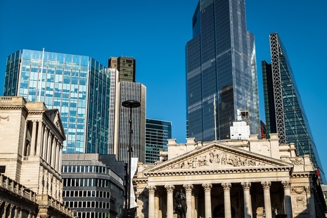 Exterior of the Bank of England (on left)  pictured with skyscraper office buildings against a blue sky -  credit: Shutterstock   