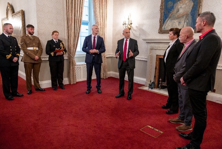 Defence Ministers John Healey MP and Alistair Carns OBE MC MP presenting the Etherton Ribbon to LGBT Veterans.