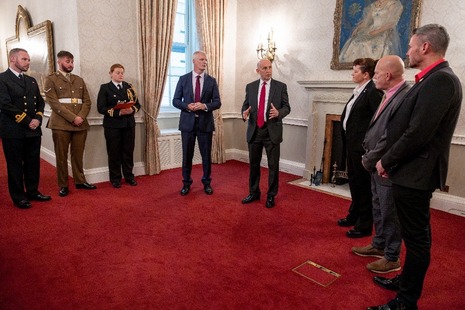 Defence Ministers John Healey MP and Alistair Carns OBE MC MP presenting the Etherton Ribbon to LGBT Veterans.