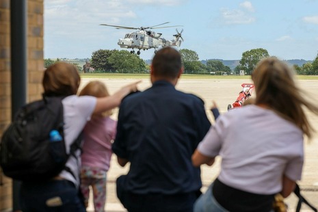 Family and friends gather at 815 Naval Air Squadron to welcome their loved ones back home after a long deployment. MOD Crown Copyright.