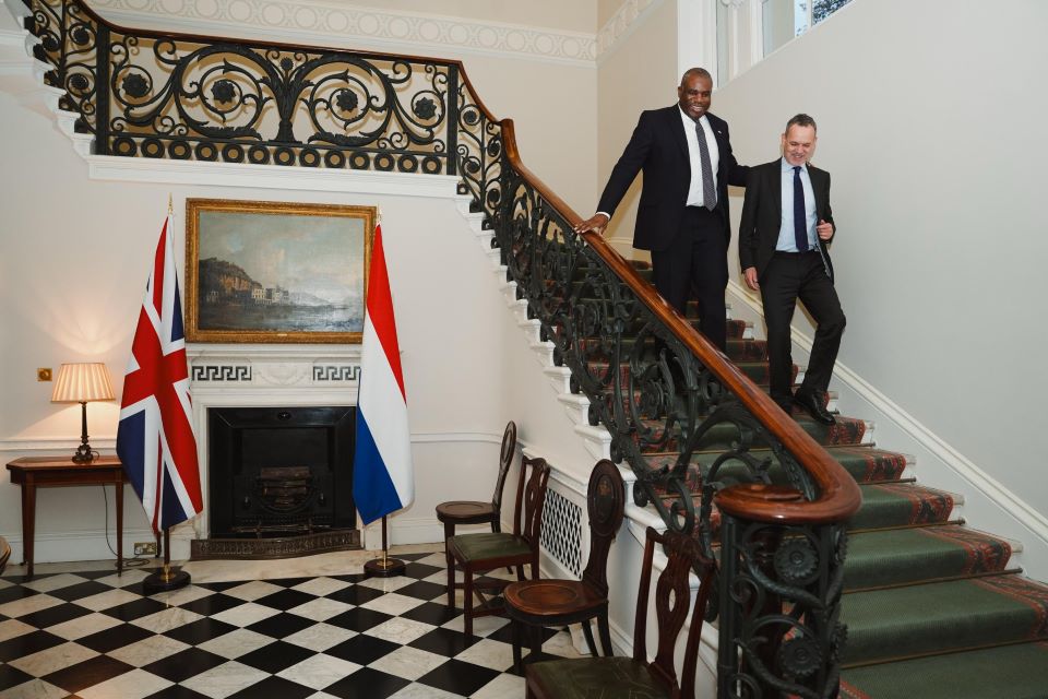 Foreign Secretary David Lammy walking down a staircase with Dutch Foreign Minister Caspar Veldcamp