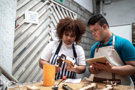 Two young people working with tools