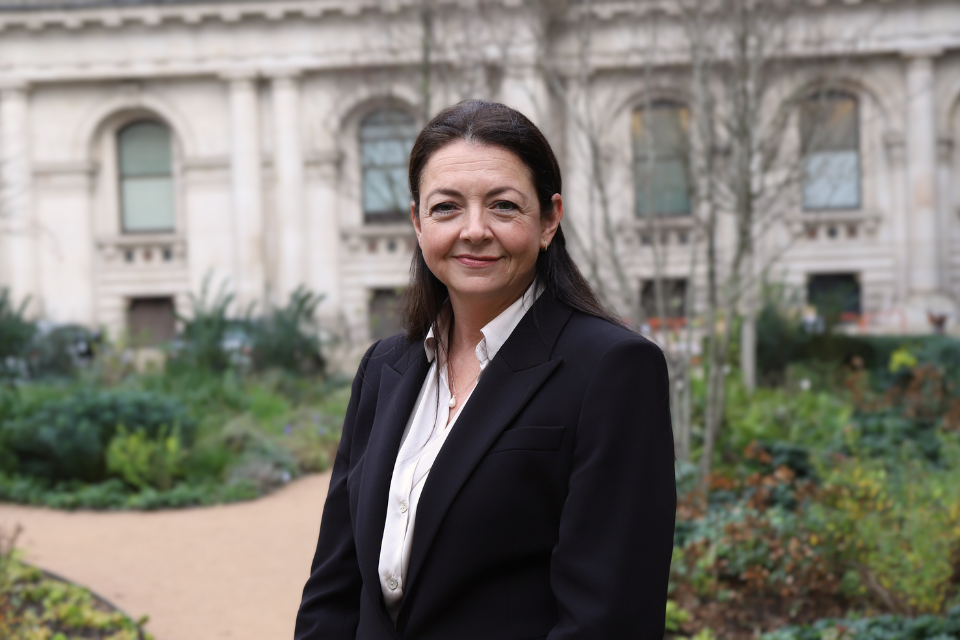 Smiling woman with a garden in the background