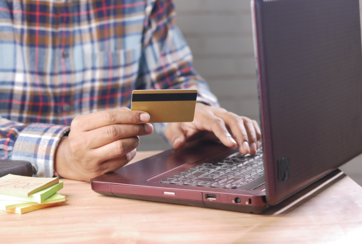 image of man at pc with credit card