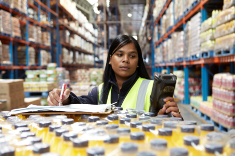 Young woman in warehouse checking stock