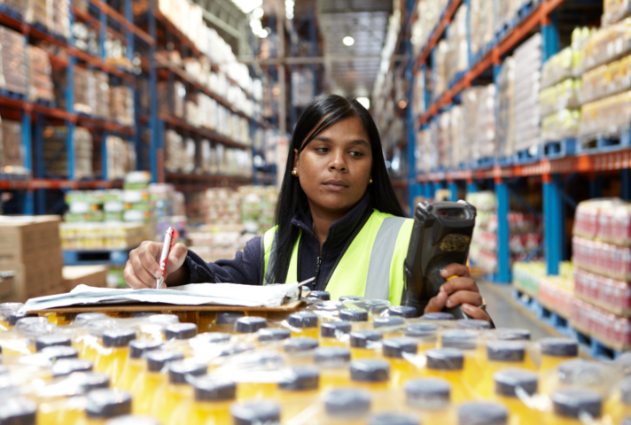 Young woman in warehouse checking stock