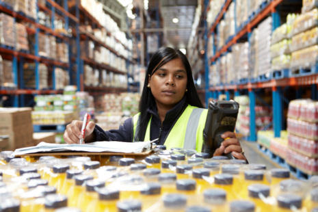 Woman in warehouse checking stock