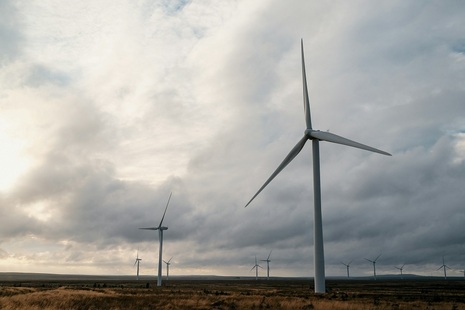 Wind turbines on an overcast day. Credit: Patrick Untersee, Unsplash