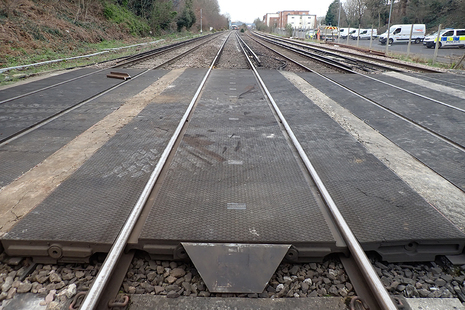 View towards Walton on Thames station along the Up Fast line showing the railway access point deck and a broken section of redundant rail.