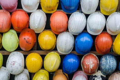 Safety helmets hanging on a wall at a construction site