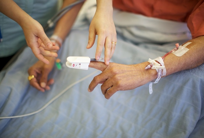 A patients being monitored in a hospice bed