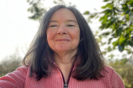 Image of Dr Sally Robinson: a woman with mid-length dark hair smiling
