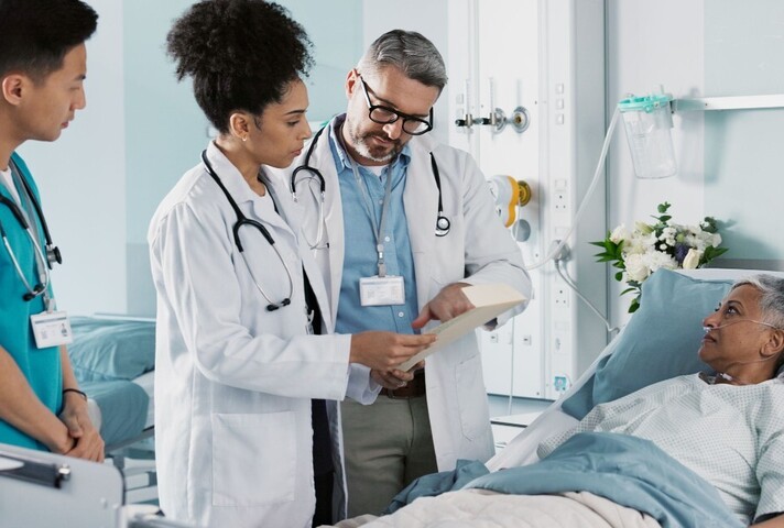 doctors checking on a patient