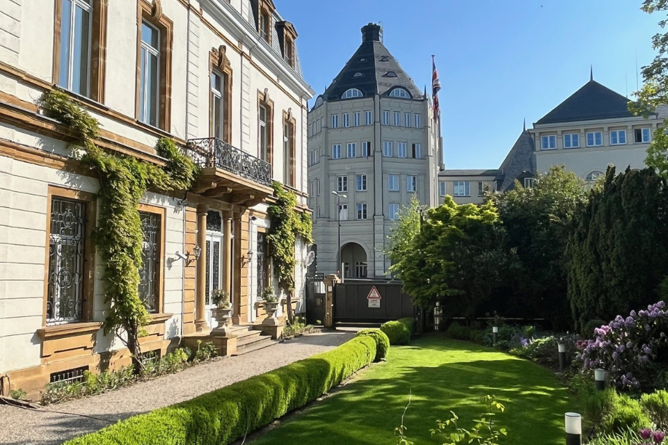 Green lawn in front of a classical facade