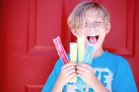 boy holding an selection of ice pops