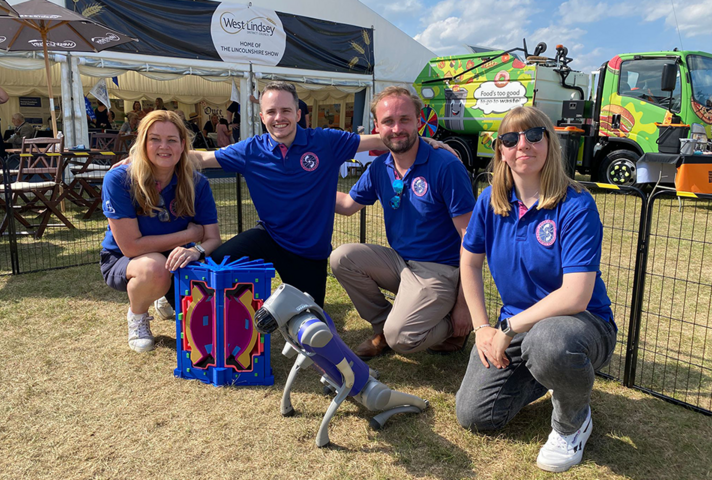 The STEP team pose with a robot dog.