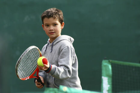 boy playing tennis