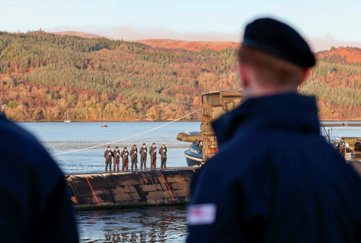 Members of HMNB Clyde line the jetty to say farewell to HMS Triumph.