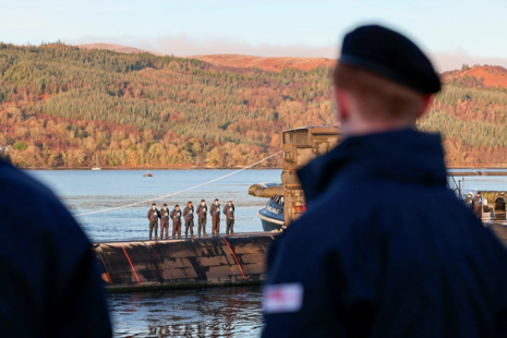 Members of HMNB Clyde line the jetty to say farewell to HMS Triumph.