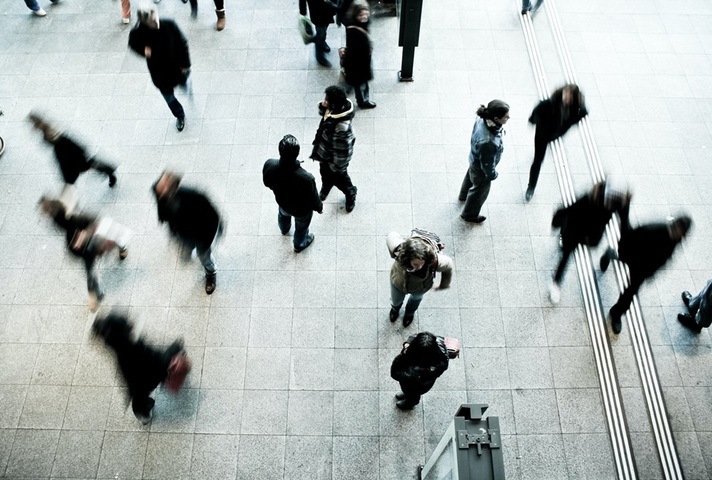 Blurred image of people on a concourse. Credit: Unsplash