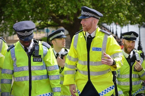 Group of 4 police officers wearing high-vis jackets. Credit: Shutterstock