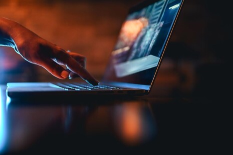 Hand typing on computer keyboard