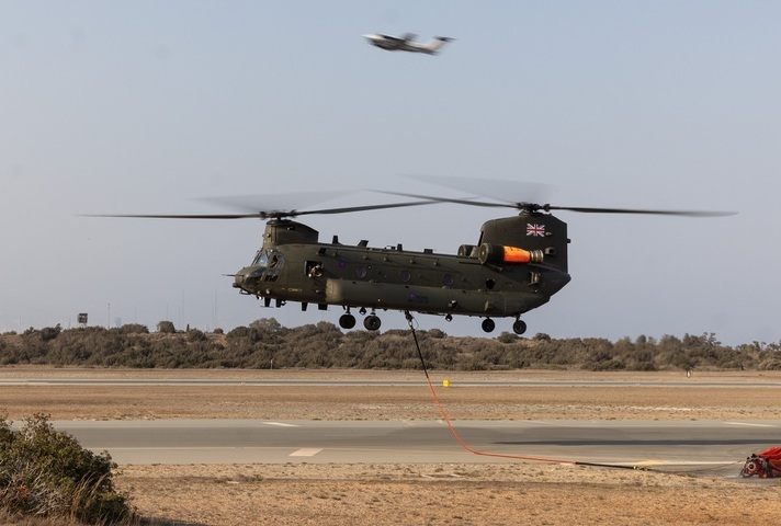  Chinook helicopter lifting off with fire-fighting equipment attached