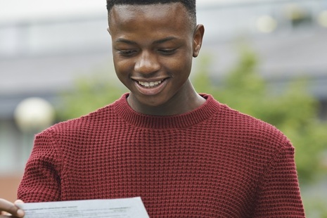 teenager looking at his exam results