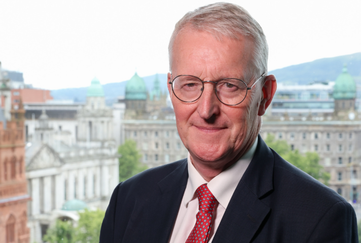 Secretary of State, Hilary Benn MP standing with Belfast City Hall in the background. 