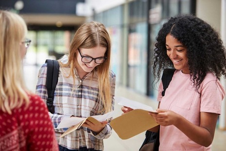 Some students smiling as they look at their exam results