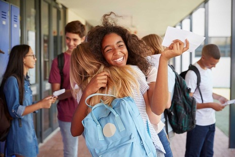 Some students hugging as they celebrating receiving their exam results