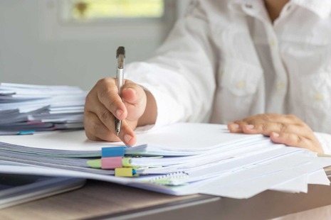 A person working at a desk with some papers