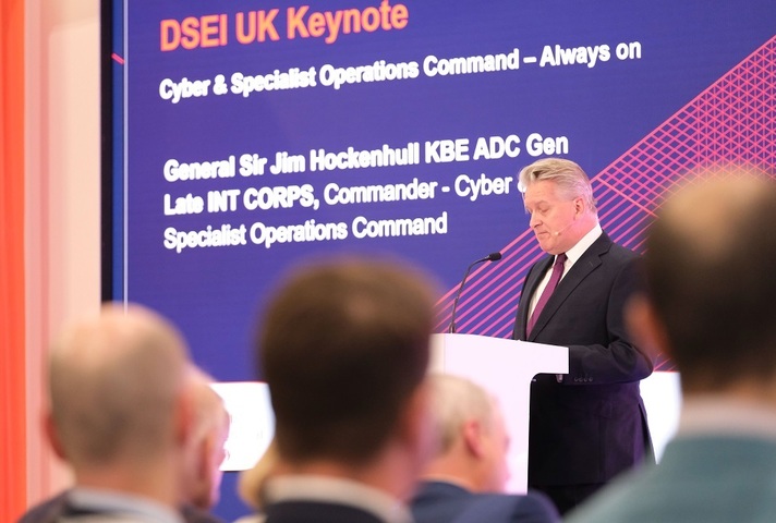 The General addressing the audience from the stage