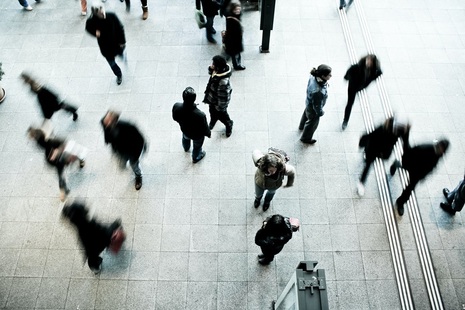 Blurred group of people wearing dark clothing. Credit: Unsplash.