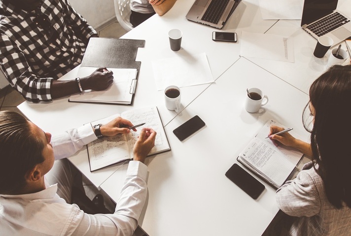 Overhead view of a business professionals meeting. Credit: Shutterstock