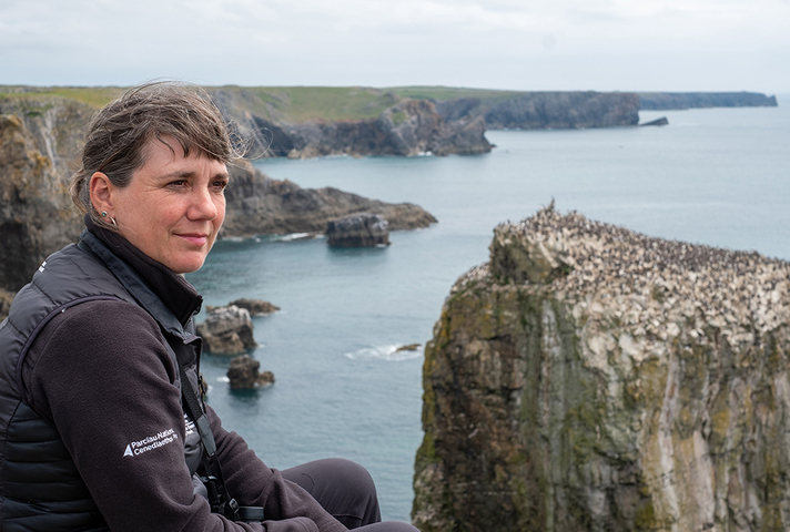 Lynne Houlston sits overlooking the cliffs and sea at Castlemartin Training Area.