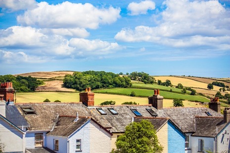 Photograph looking over the roofs of some houses to the hills beyond