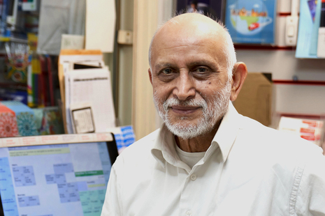 An older man smiling at the camera