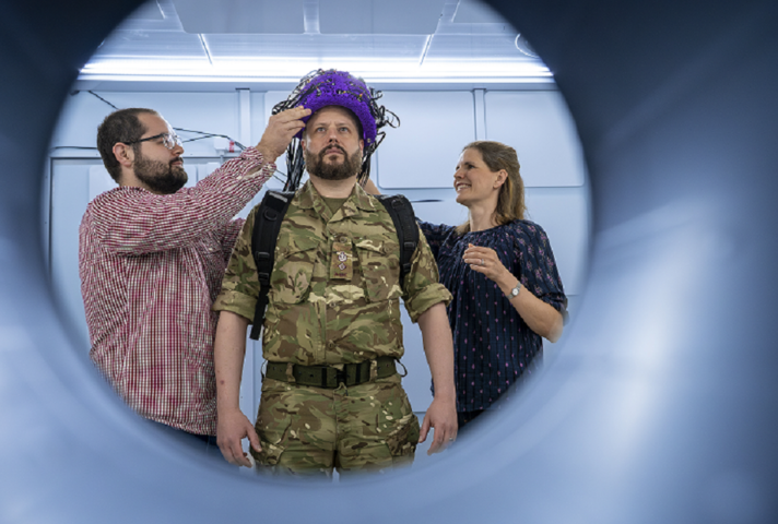 A soldier wearing an experimental brain scanner helmet