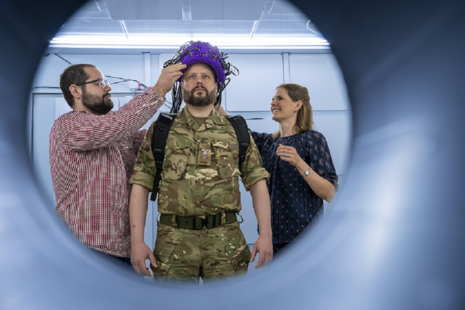 A soldier wearing an experimental brain scanner helmet