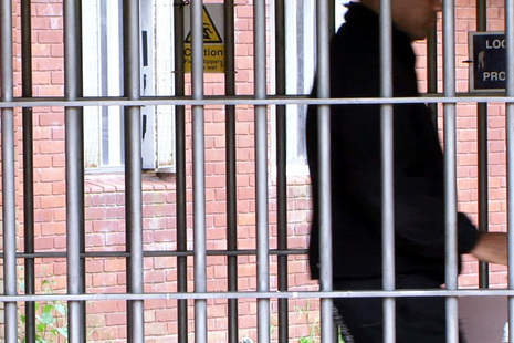 Prison officer walking past gate