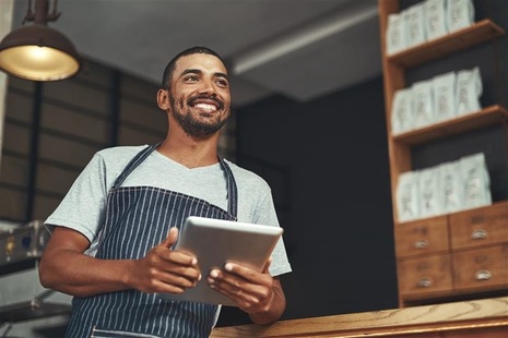 A young business owner in his cafe