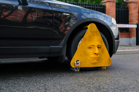 Yellow wheel clamp on a car