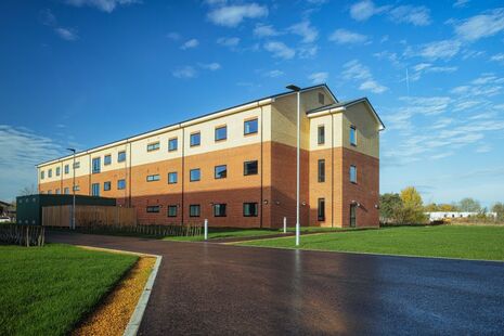 An accommodation block standing inside a military training base