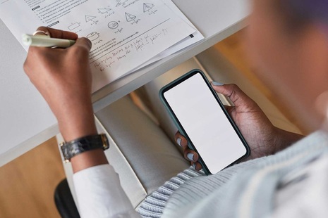 A person using a mobile phone during an exam