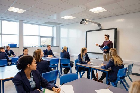 A teacher talking to students in a classroom
