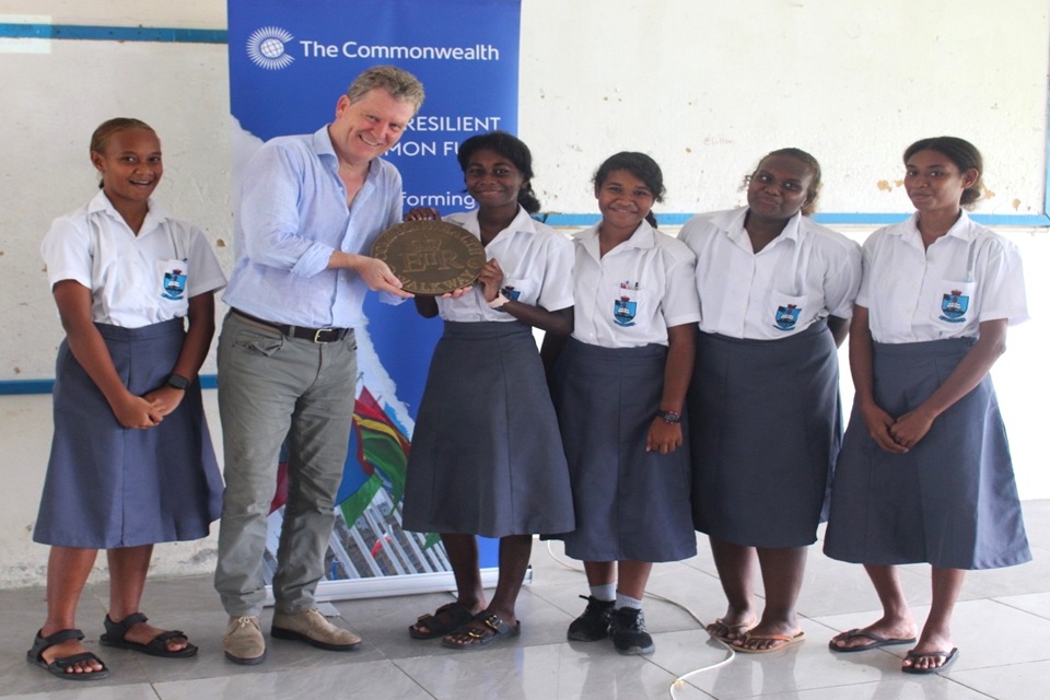 High Commissioner Paul Turner with KGVI Form 4 girls marking International Women's Day, sharing a moment of Commonwealth Day.
