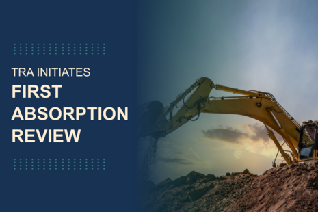 Graphic with the text ‘TRA initiates first absorption review’ on a dark blue background beside an image of a large yellow excavator moving soil against a sunset sky