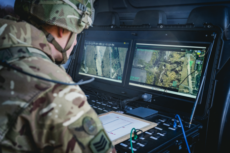 Soldier looking at two screens side by side
